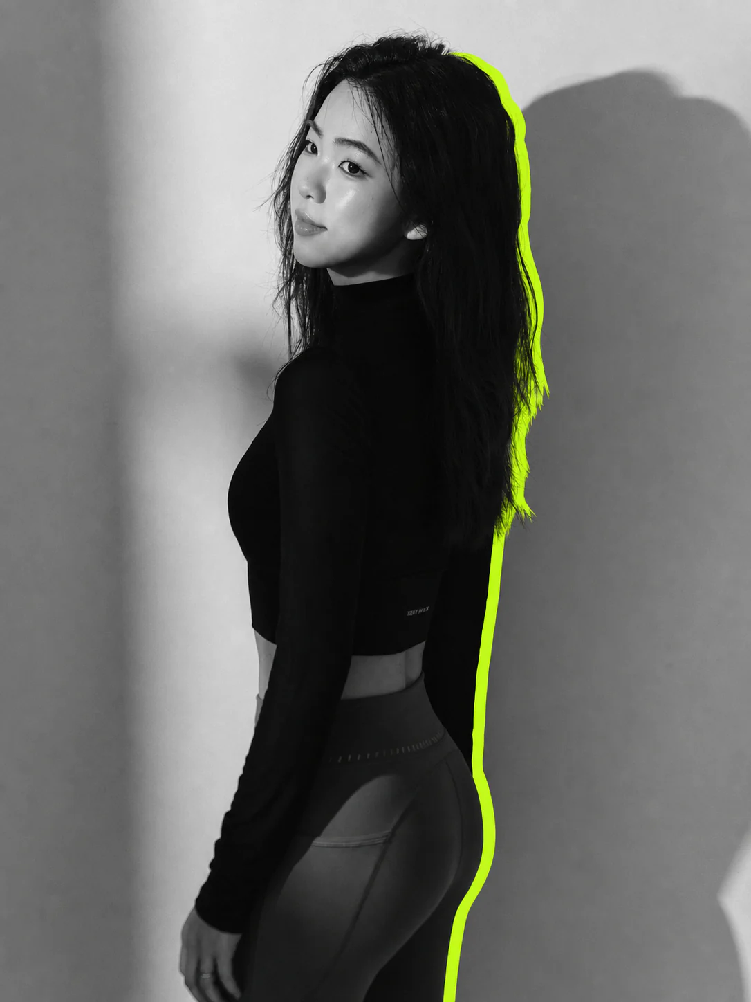 Jiaying Chen standing in sportswear against a monochrome studio background, with a fluorescent green offset outline